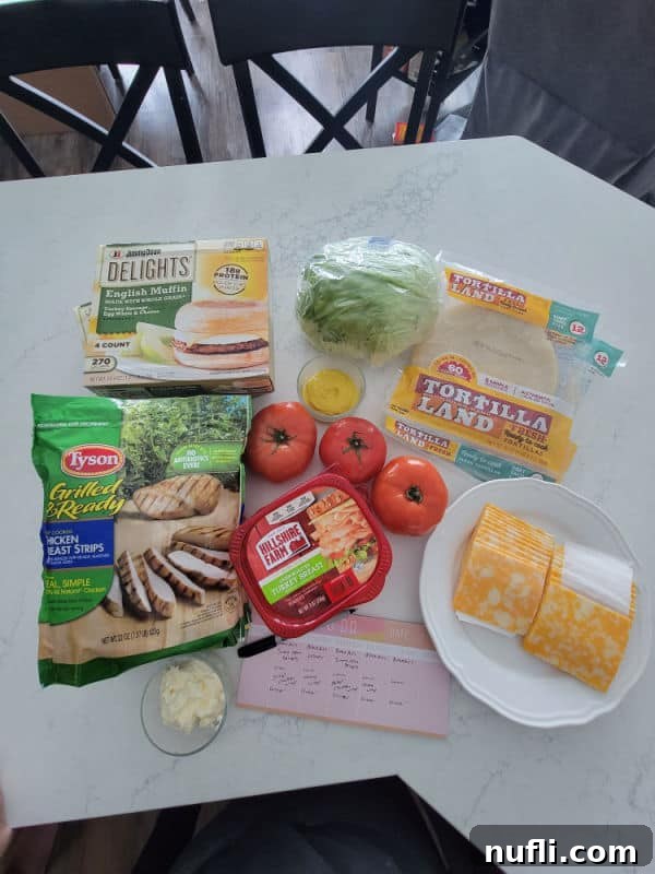 delights, tyson grilled chicken, hillshire farms ham, cheese slices, tomatoes, mustard, and tortillas on a counter 