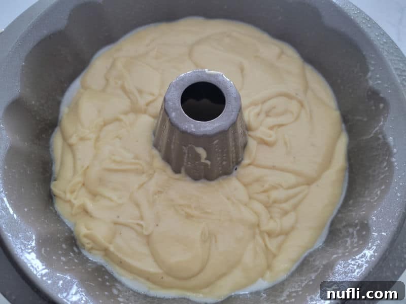 Eggnog cake batter in a Bundt cake pan before baking