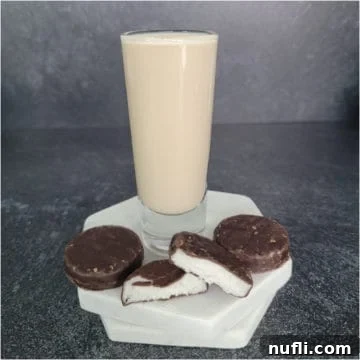 Peppermint patty chocolate next to a shot glass filled with peppermint patty shot
