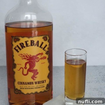Fireball shot in a glass next to a bottle of Fireball