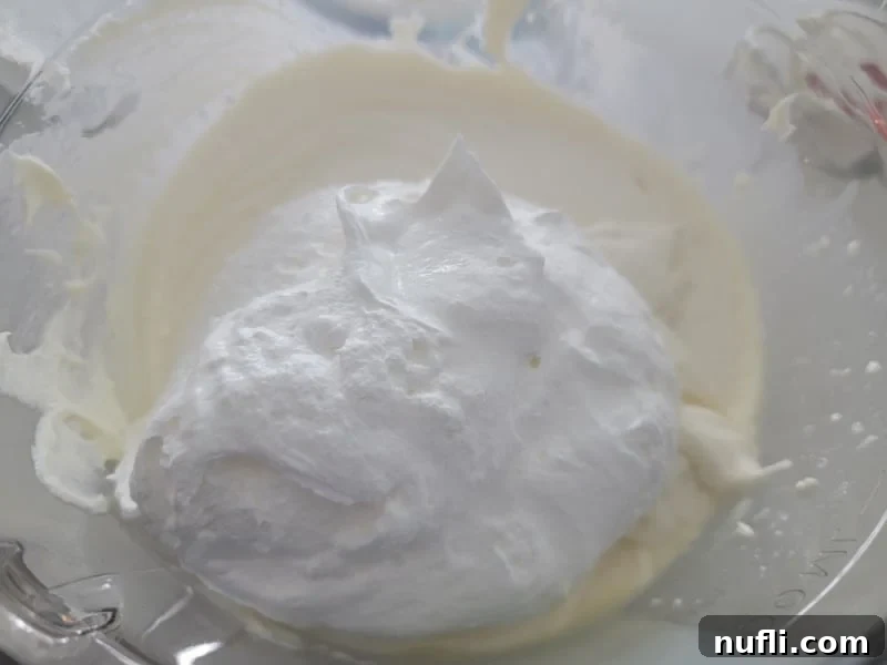 Cool whip on cream cheese in a glass bowl for no bake easy cherry cheesecake dessert dip