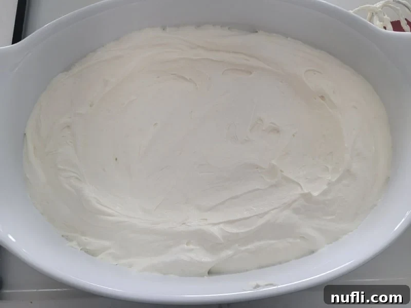 Cheesecake mixture spread in a white serving bowl for easy no bake cherry cheesecake dip