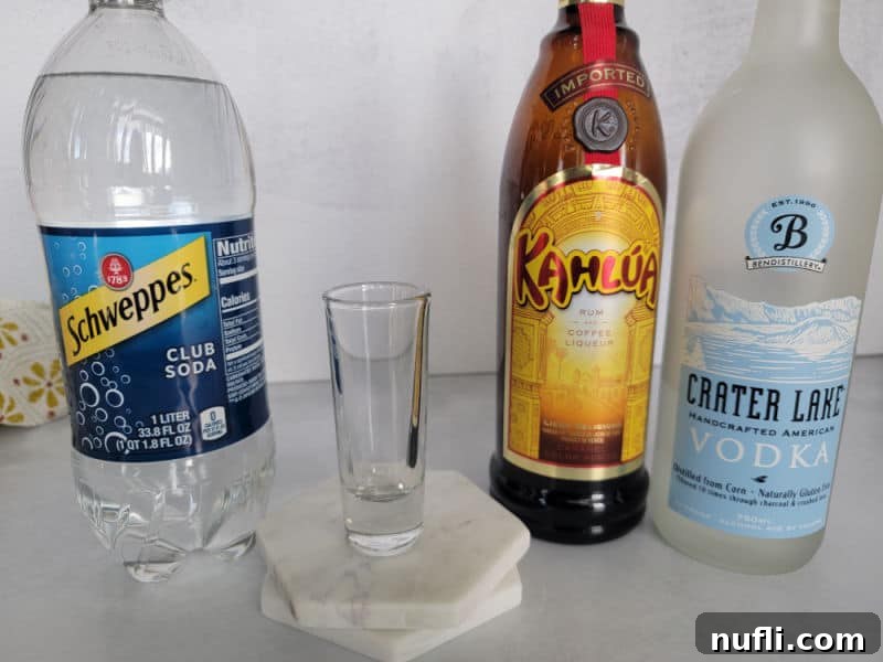 Mind Eraser Shot and Cocktail Creations 3 Mind Eraser Shot ingredients Club Soda, Kahlua Coffee Liqueur, and Vodka with a shot glass
