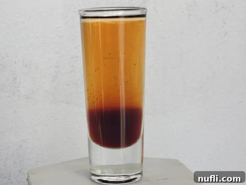 Mind Eraser Cocktail Shot in a glass cocktail shot glass on a marble coaster