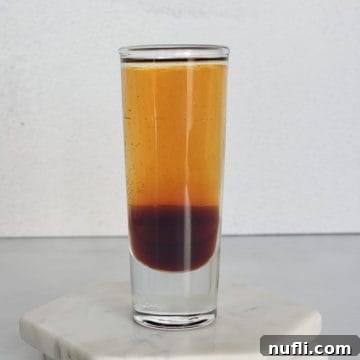 Mind Eraser Shot and Cocktail Creations 6 Layered mind eraser shot in a glass on coasters