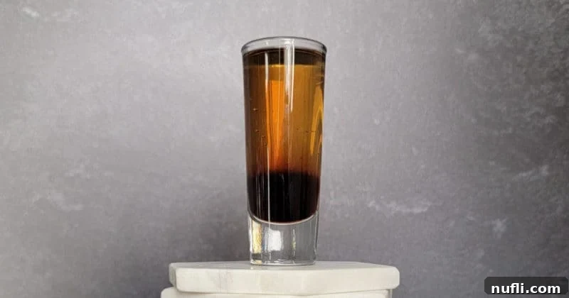 Mind Eraser Shot and Cocktail Creations 7 Mind Eraser Shot in a glass cocktail shot glass on a coaster