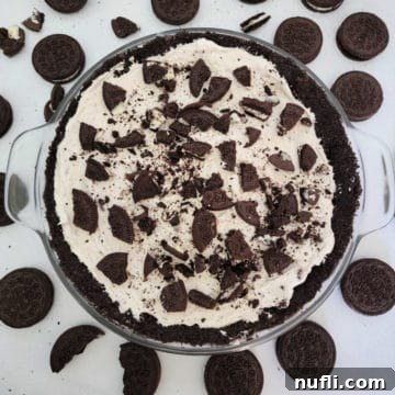 No bake Oreo cheesecake in a glass dish surrounded by Oreo Cookies