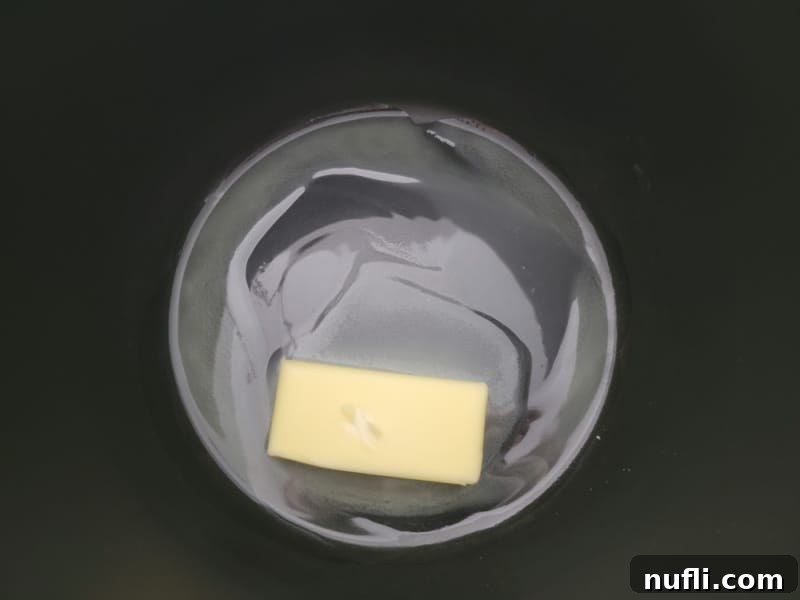 Butter melting in a dark pot for the best Rice Krispie Treats