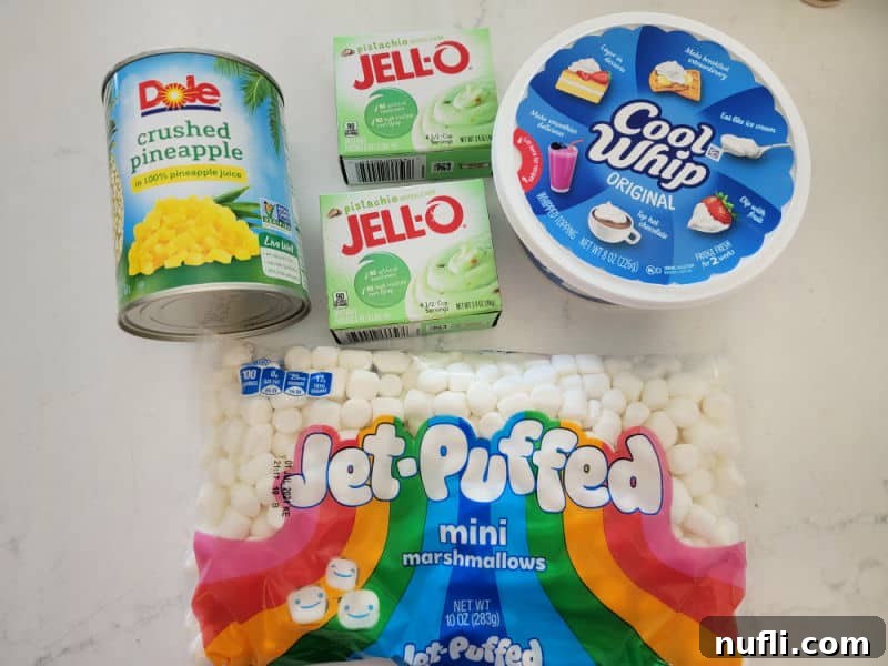 Watergate Salad ingredients, crushed pineapple, pistachio pudding mix, cool whip, mini marshmallows