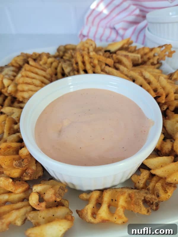 Prepared Fry Sauce in a white bowl, surrounded by crispy waffle fries, ready for dipping