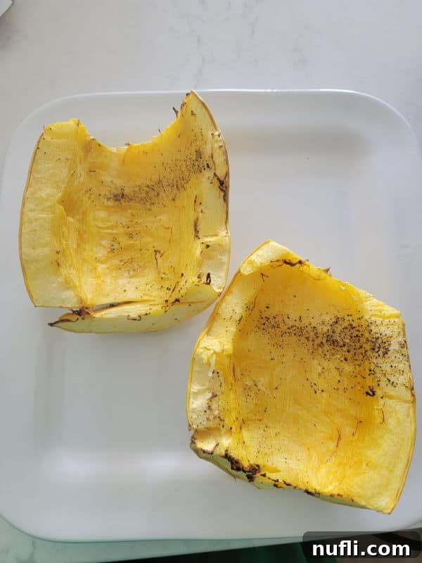 Easy Air Fryer Spaghetti Squash 6 A serving of air fried spaghetti squash, beautifully scraped into delicate strands and presented on a clean white plate.