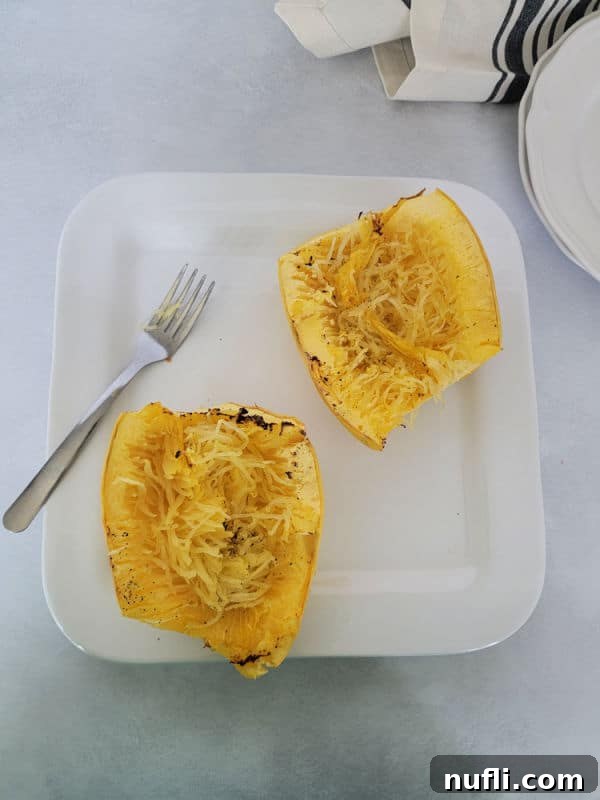 Air fryer spaghetti squash on a white plate with a fork