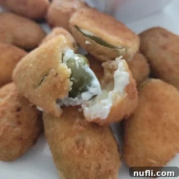 Crispy Air Fryer Frozen Jalapeno Poppers 7 Air fried jalapeno poppers on a white plate