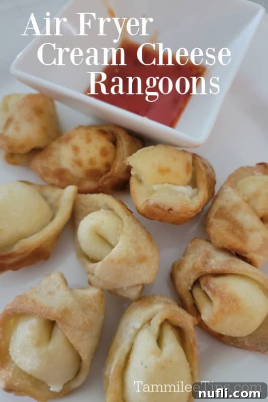 Air fryer cream cheese rangoons over a plate of air fried rangoons and sauce 
