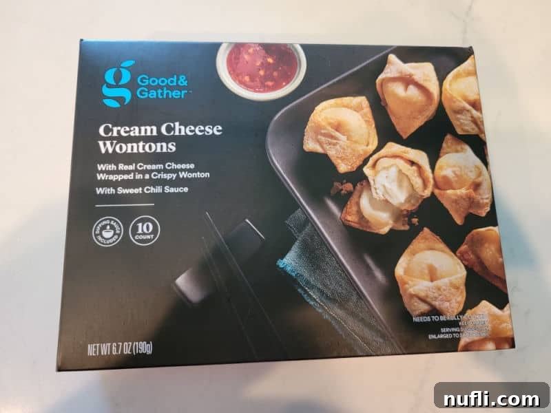 A vibrant red box of frozen cream cheese wontons, ready for air frying