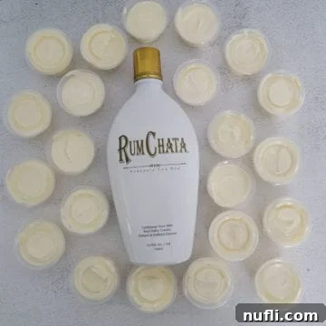 RumChata Pudding Shots spread around a bottle of RumChata, showcasing a festive dessert