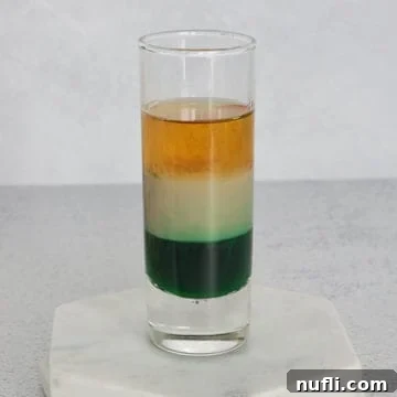 Irish Flag layered shot in a glass shot glass on a marble coaster