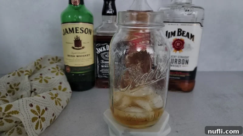 Mason jar filled with ice and liquor