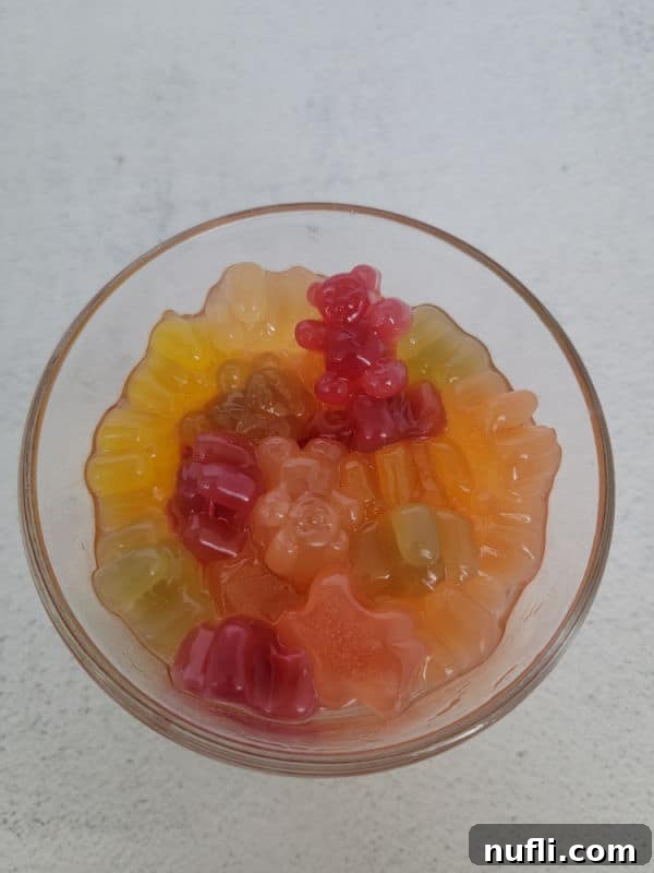 Tipsy Teddies 8 puffy gummy bears in a glass bowl with liquid