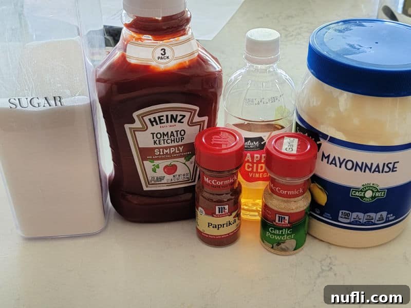 Effortless Homemade Yum Yum Sauce 3 Homemade Yum Yum sauce ingredients, sugar, tomato ketchup, paprika, apple cider vinegar, garlic powder, and mayonnaise