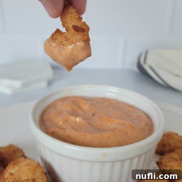 Effortless Homemade Yum Yum Sauce 8 hand holding a shrimp dipping down into a bowl of Yum Yum Sauce