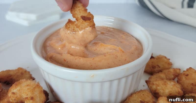 Effortless Homemade Yum Yum Sauce 9 Shrimp dipping into Yum Yum Sauce in a white bowl