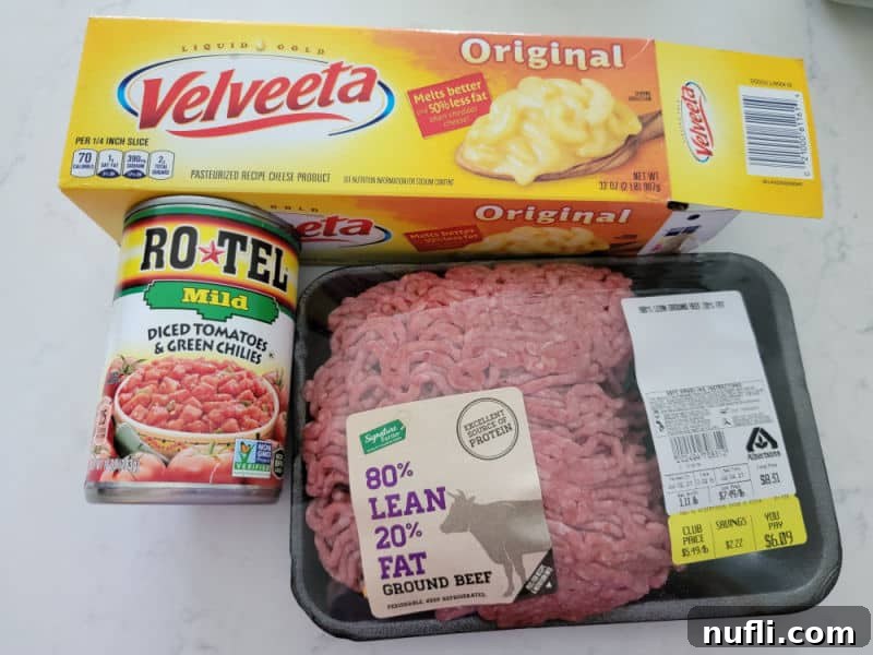 The Easiest 3-Ingredient Velveeta Rotel Ground Beef Dip 3 The essential ingredients for Velveeta Rotel Dip with Ground Beef: a block of Velveeta cheese, a can of Rotel Mild Diced Tomatoes and Green Chilies, and a package of 80/20 ground beef.