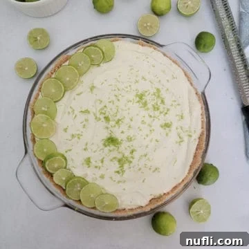 Cool & Creamy Key Lime Pie 10 No bake key lime pie garnished with lime slices next to key limes