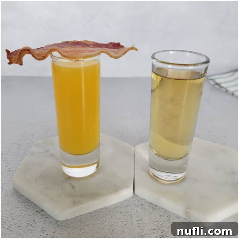St Patrick's Day Sips & Shots 14 A unique Irish Breakfast Shot featuring orange juice in one shot glass topped with a crispy bacon slice, and Jameson Irish Whiskey in another, creating a playful and spirited combination.