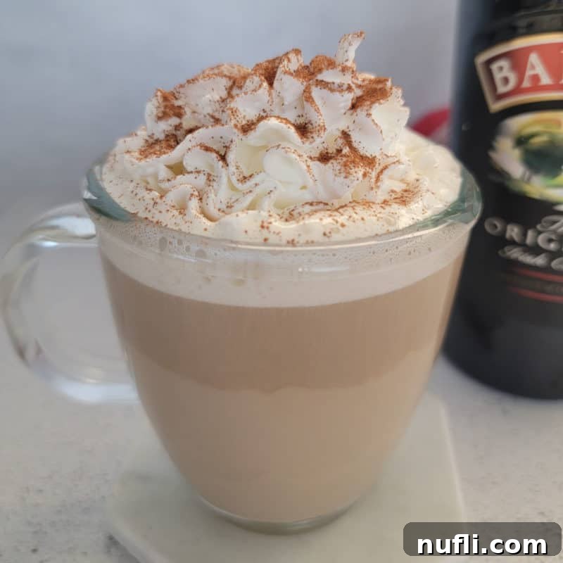 St Patrick's Day Sips & Shots 7 A warm, inviting glass of Bailey’s Coffee, elegantly served in a clear mug and crowned with a generous dollop of whipped cream, perfect for a cozy moment.