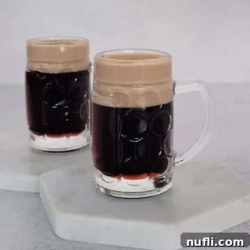Two baby Guinness shots on white coasters