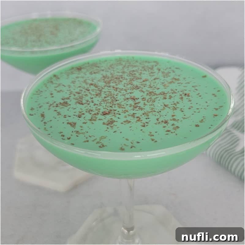 Green Grasshopper Cocktail with chocolate shavings as a garnish in a coupe glass