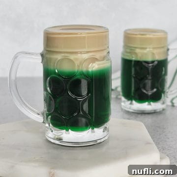 Leprechaun Beer layered shot in a mini beer glass on a white coaster