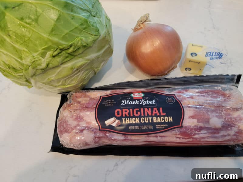 cabbage, onion, butter, and bacon on a white counter