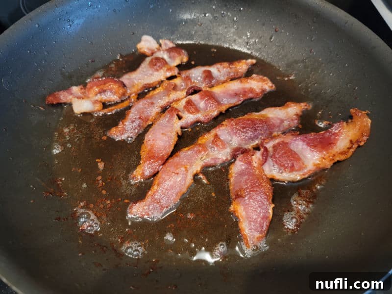 Bacon cooking in a frying pan