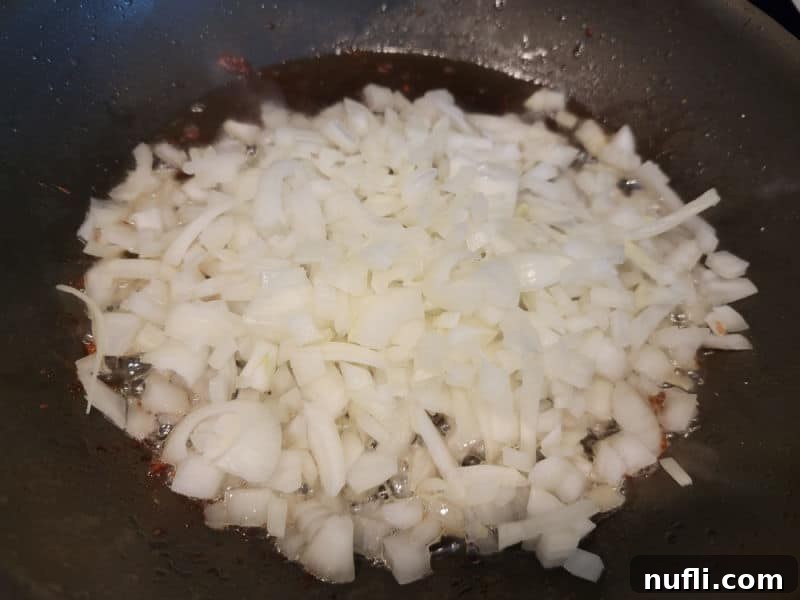 Onions in bacon grease in a frying pan