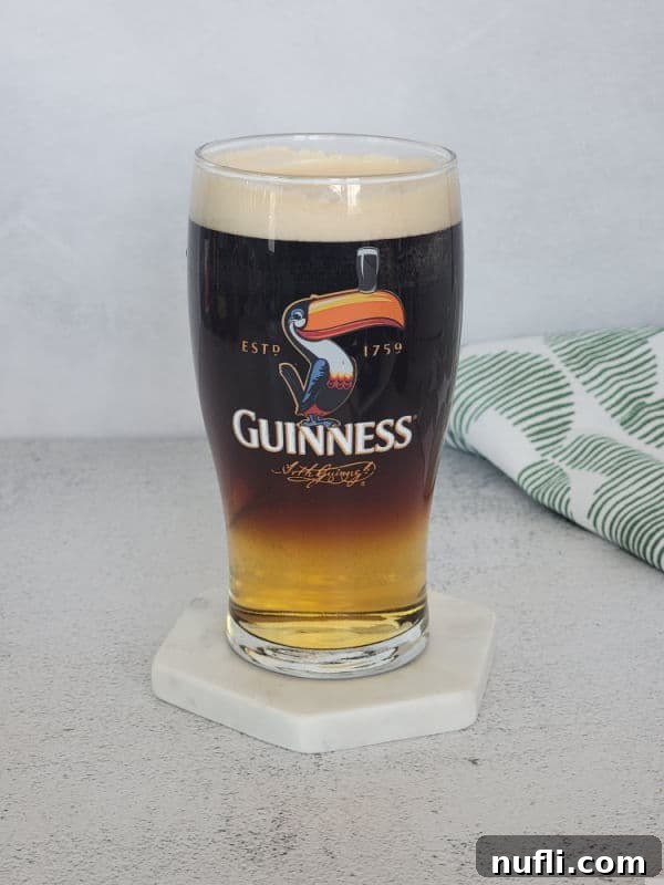 Guinness glass with layered drink in it