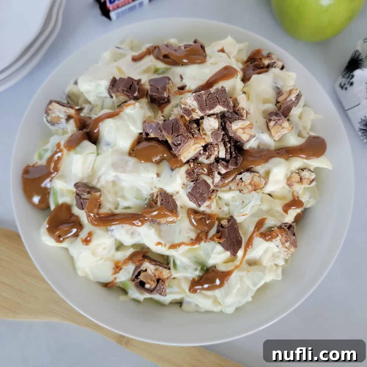 Apple and Snickers Salad in a white bowl