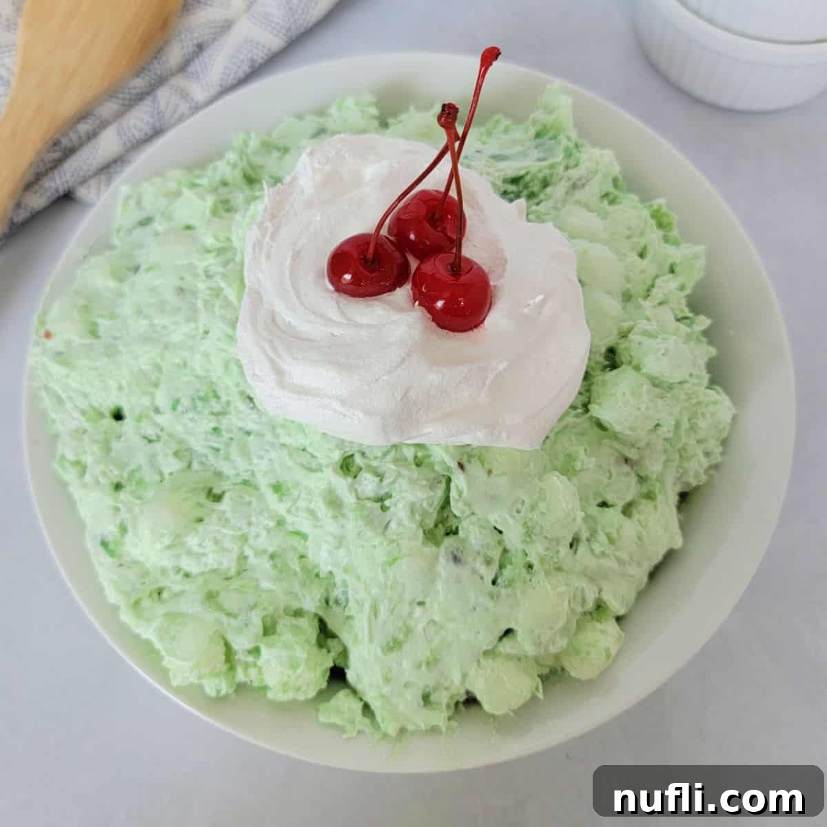 Green watergate salad with cool whip and maraschino cherries