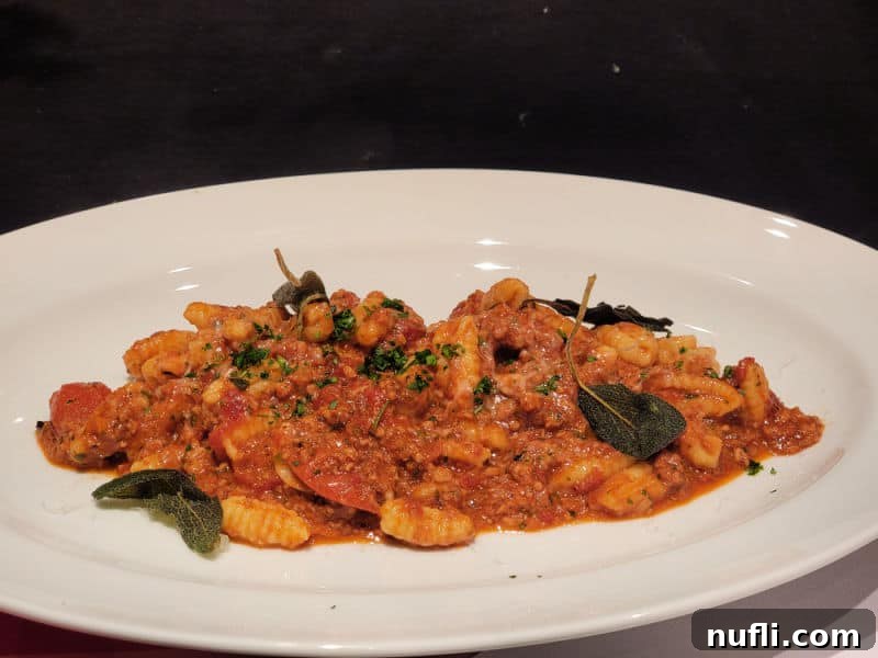 Carnival Radiance 4-Day Baja Mexico Escape 8 cavatelli pasta on a white plate with basil leaves
