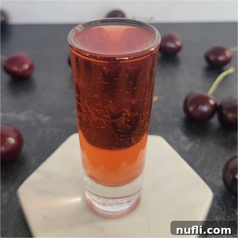 The Art of Grenadine Cocktails 15 A red shot surrounded by fresh cherries, highlighting the vibrant color.