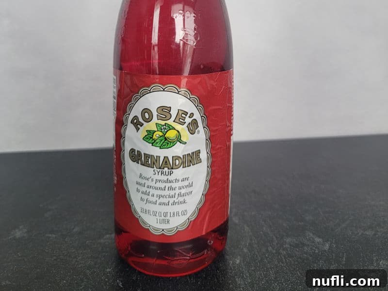 The Art of Grenadine Cocktails 3 A bottle of Rose's Grenadine Syrup, a common brand for cocktail mixing.