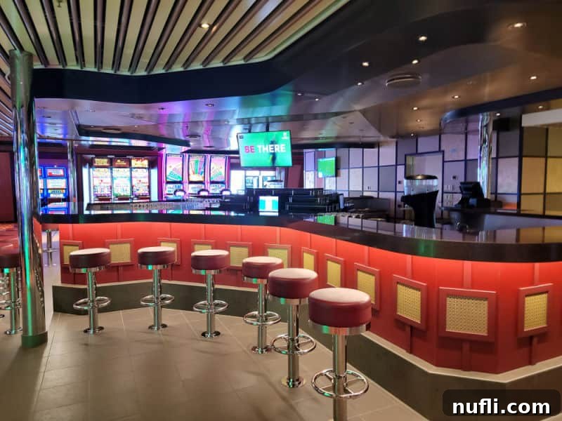 Curved bar with stools and slot machines in the background