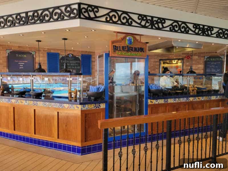 Blue Iguana Cantina sign next to counters with servers and serving dishes.
