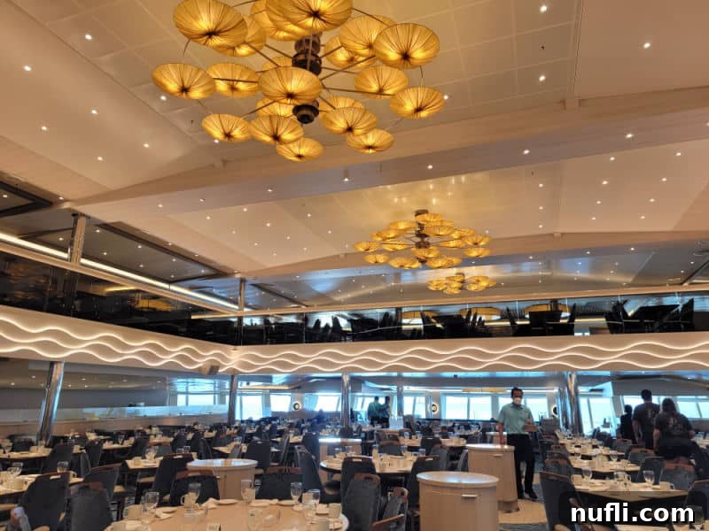 Chandeliers over a large dining room with servers