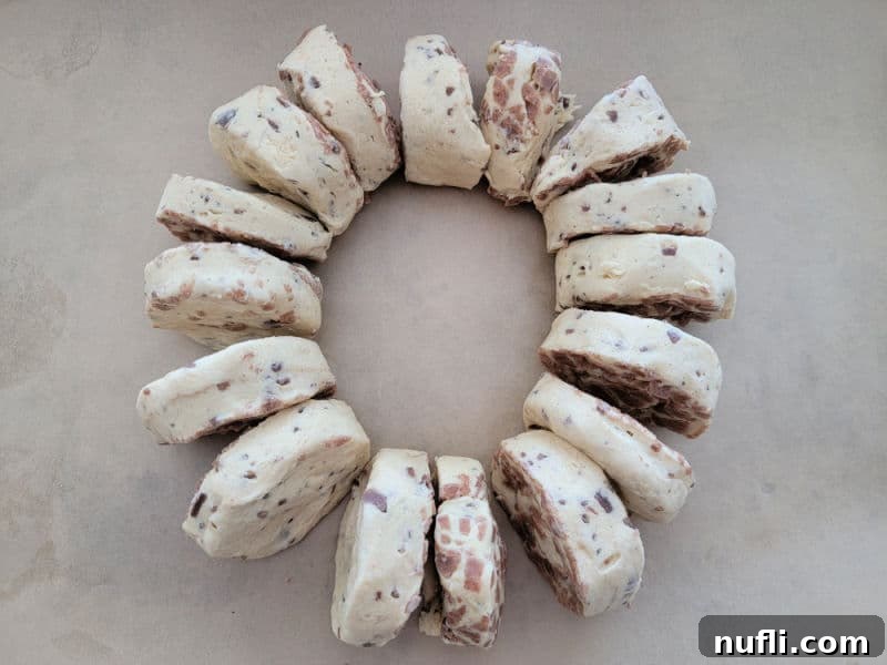 Delicious Easy Cinnamon Roll King Cake 5 Cinnamon rolls in a circle on parchment paper