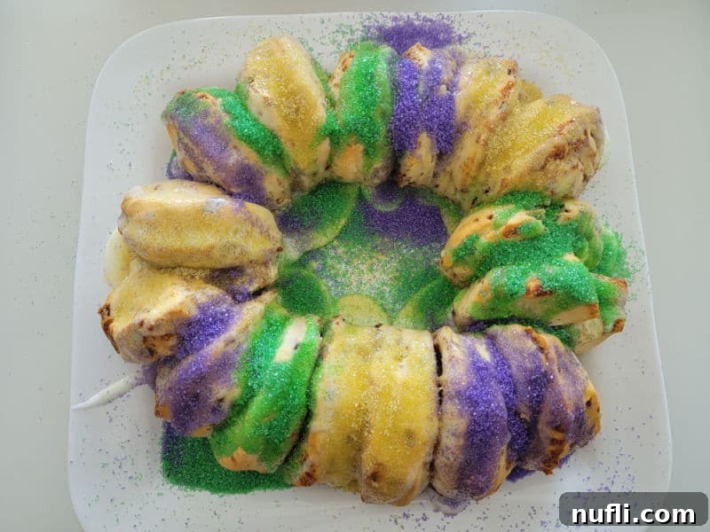 Delicious Easy Cinnamon Roll King Cake 8 green, gold, and purple sprinkles on cinnamon rolls