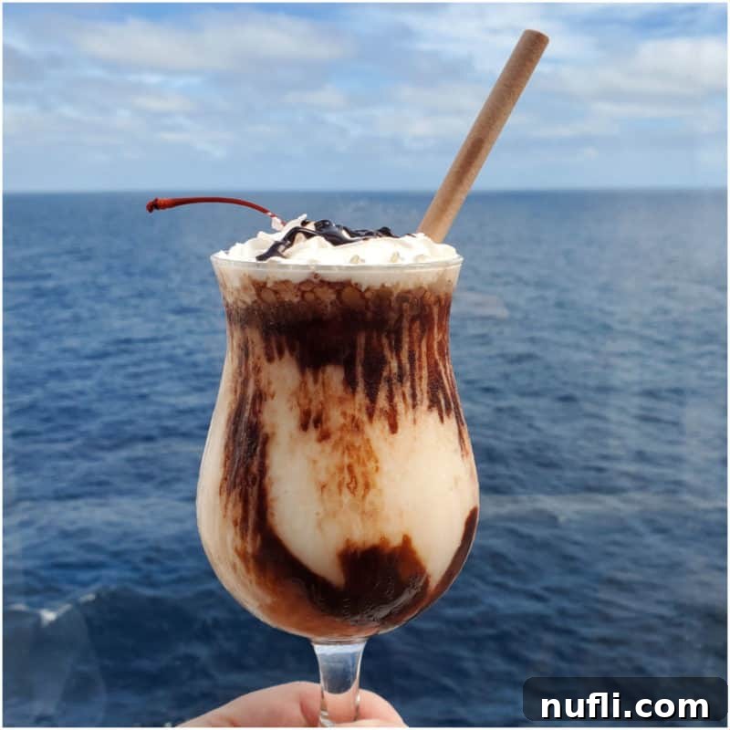 Mocha Chocolate Getaway cocktail being held with a view of the ocean.