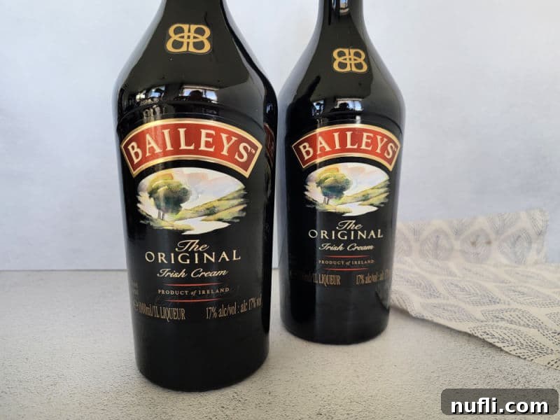 Two bottles of Baileys Original Irish Cream by a cloth napkin.