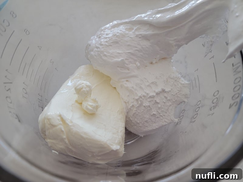 cream cheese and marshmallow cream in a glass bowl 